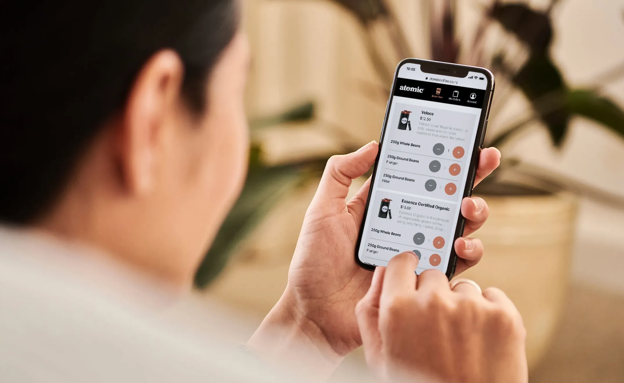 Customer browsing Atomic coffee blends and placing an order in the Brew Run PWA on a phone