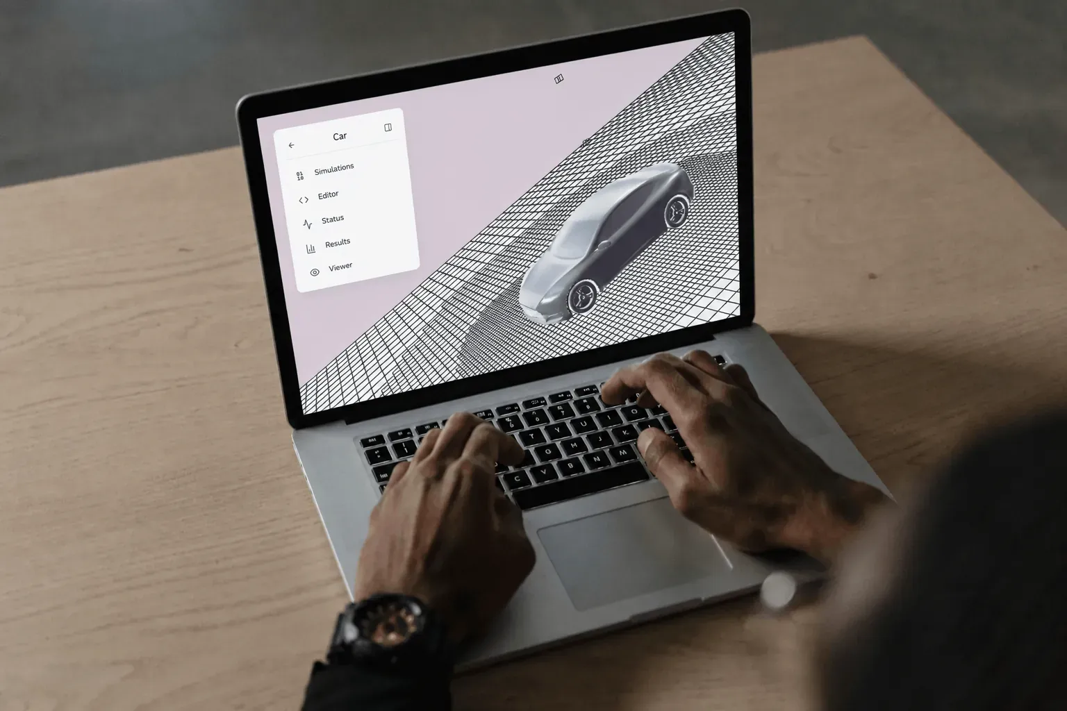 Flowdeck CFD app showing a 3D car on a simulation mesh grid, used on a laptop