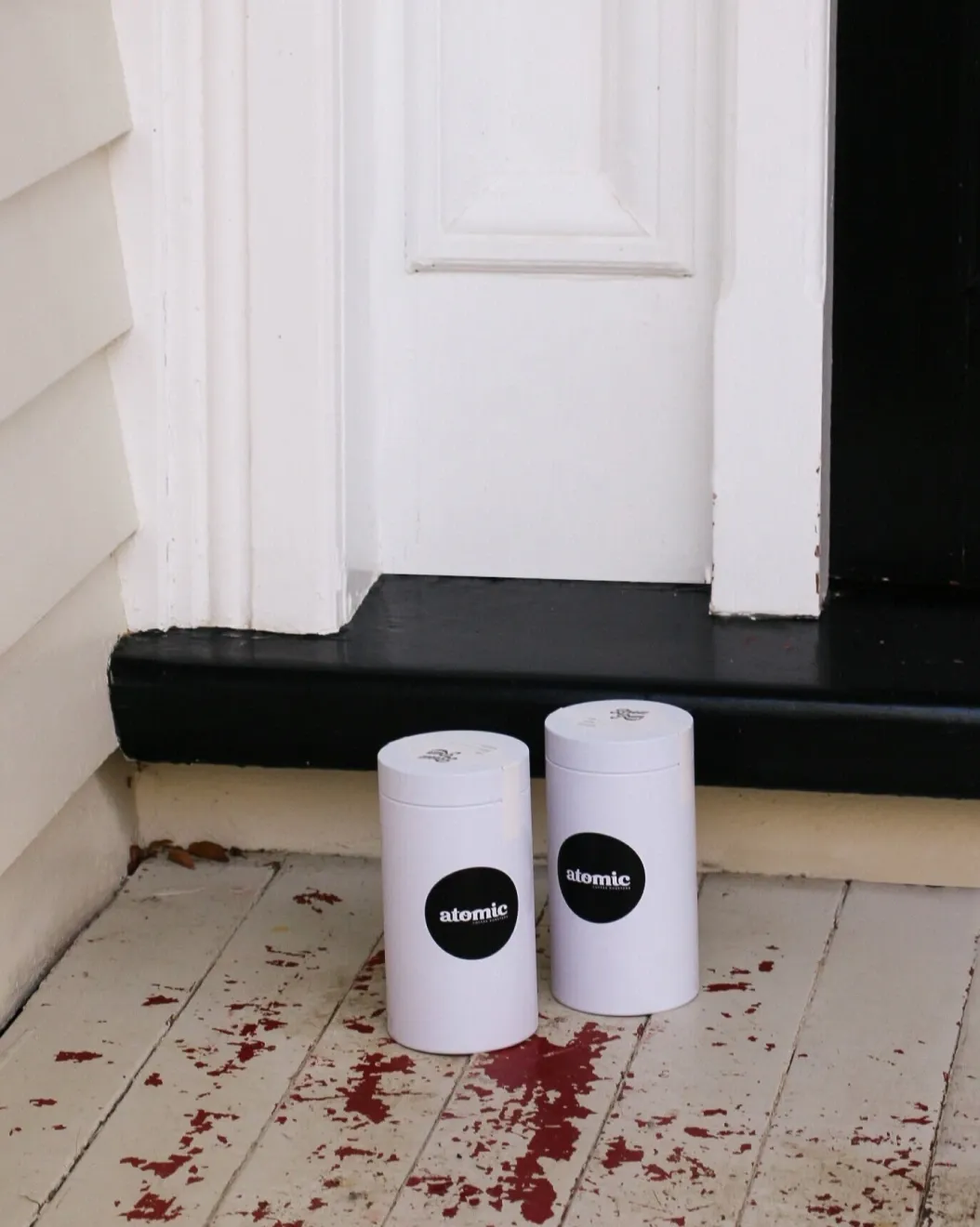 Two reusable Atomic coffee canisters delivered to a customer's front door
