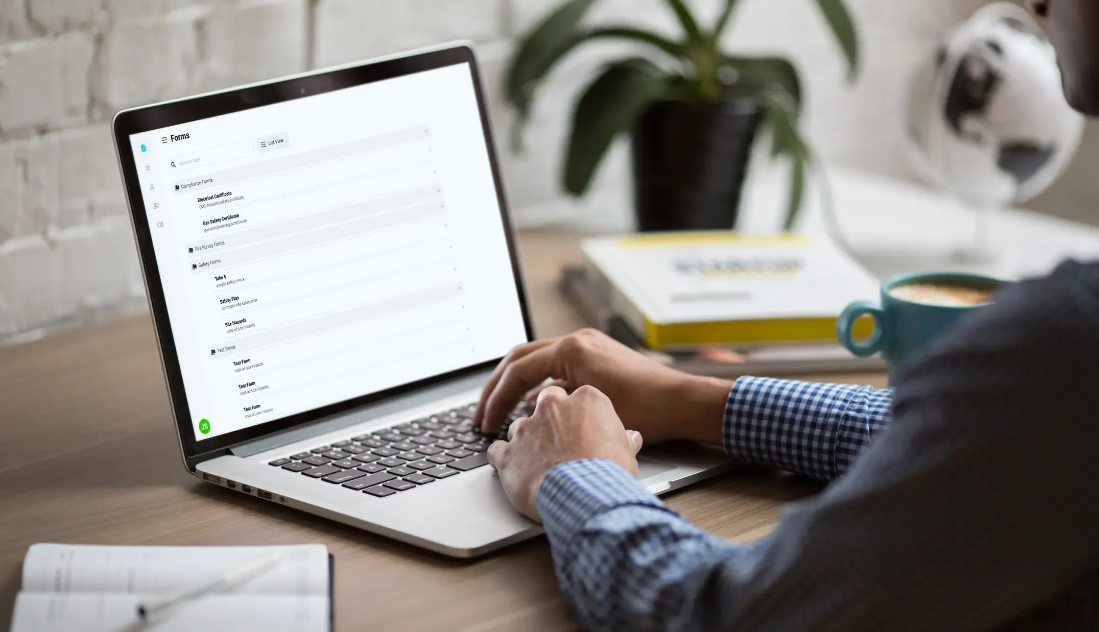 Tradesperson at a laptop browsing the Forms 4 Tradies list of compliance and safety forms