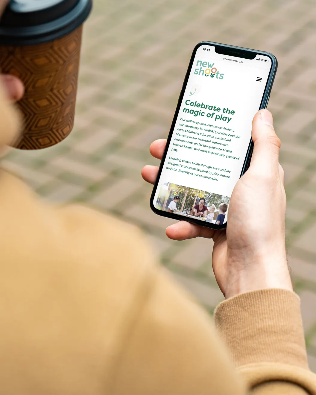 New Shoots mobile site Celebrate the magic of play page on a phone held in hand