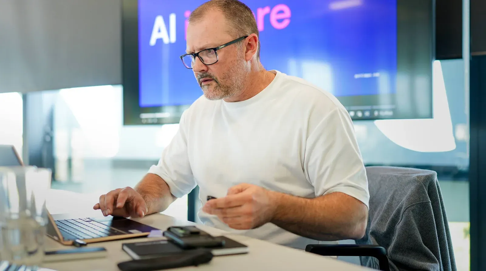 A Putti AI engineer working at a laptop during an AI event