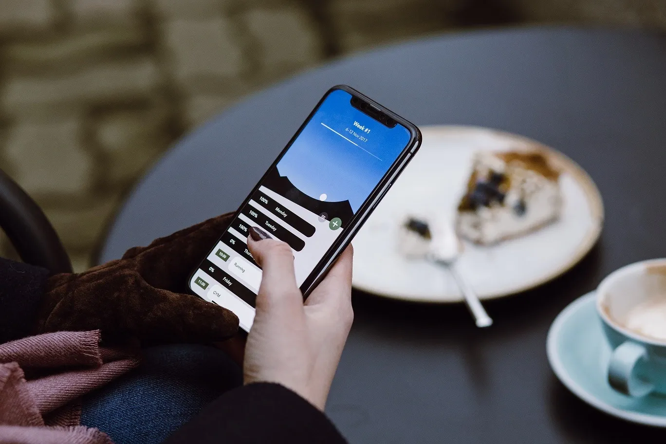A person using a business app on a smartphone in a modern New Zealand office