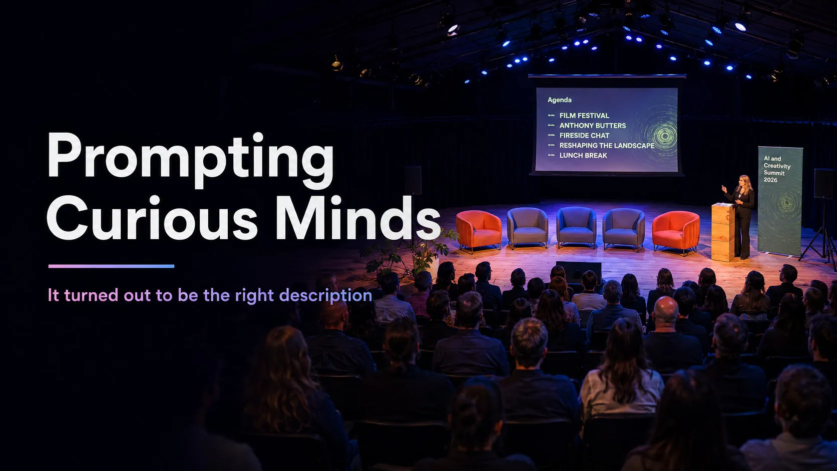 Speaker on stage before an audience with a summit agenda slide, titled Prompting Curious Minds