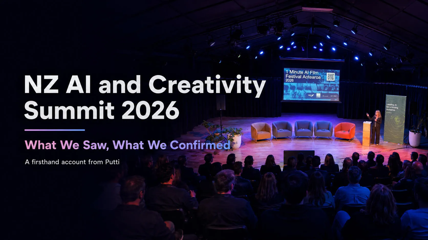 NZ AI and Creativity Summit 2026 stage with a speaker, empty panel chairs, and an audience in a dark venue