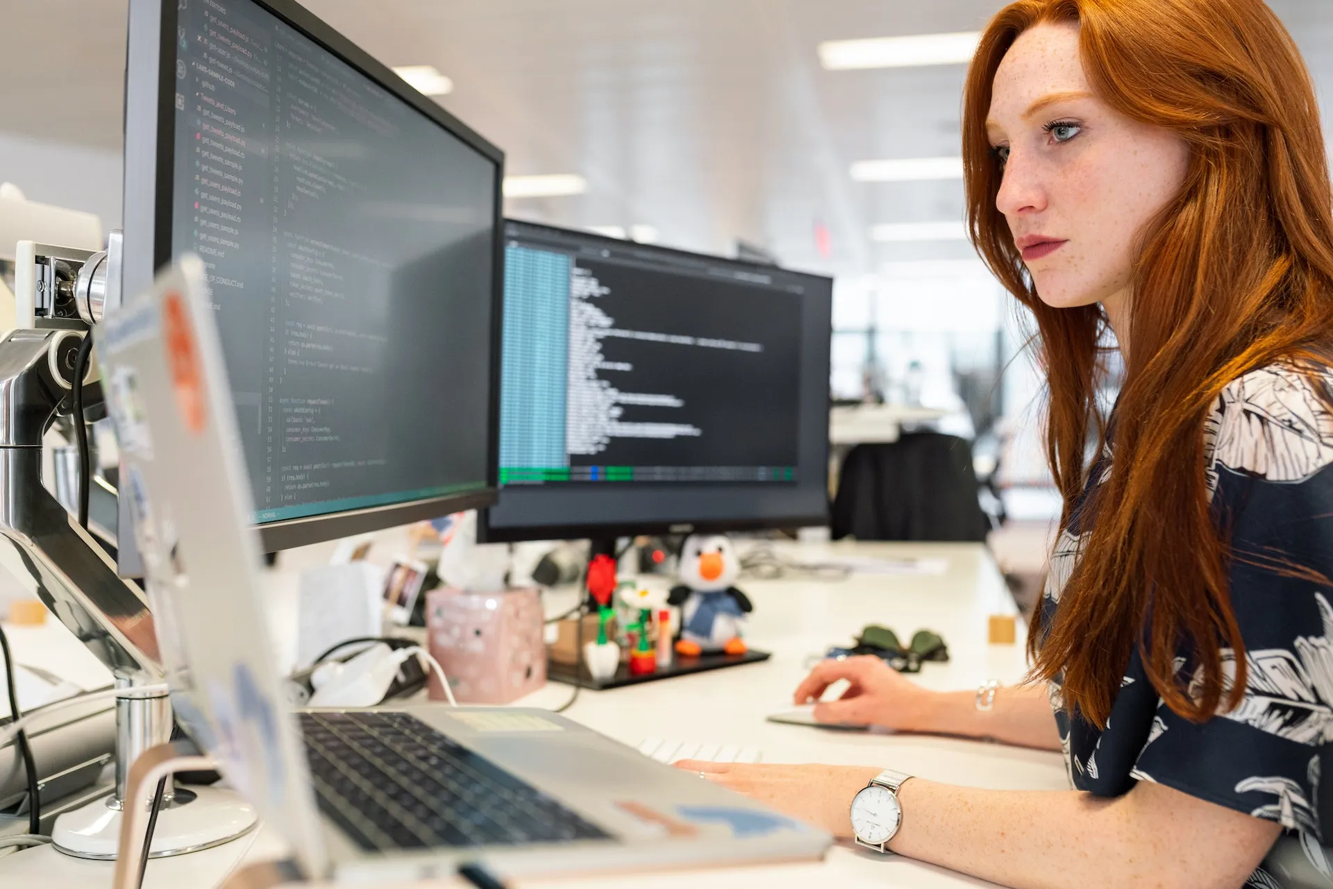 A developer working on a laptop with code on screen, representing modern software development considerations for business