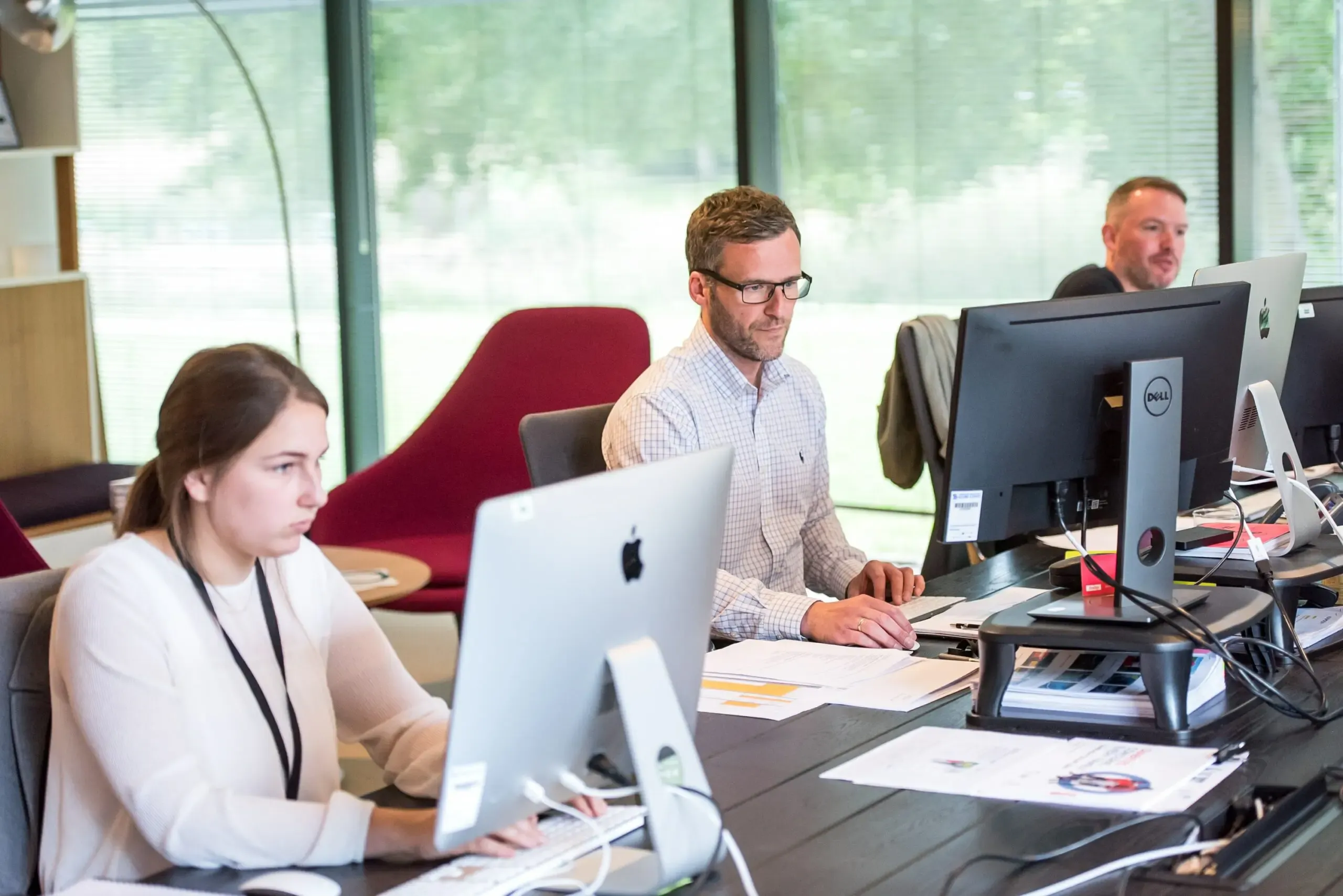 Software QA testing process illustrated, a team reviewing code and test results on screens