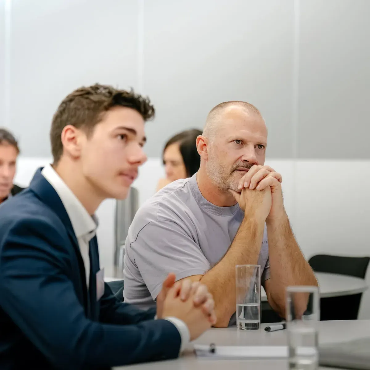 Two attendees weighing up AI options at a Putti client workshop