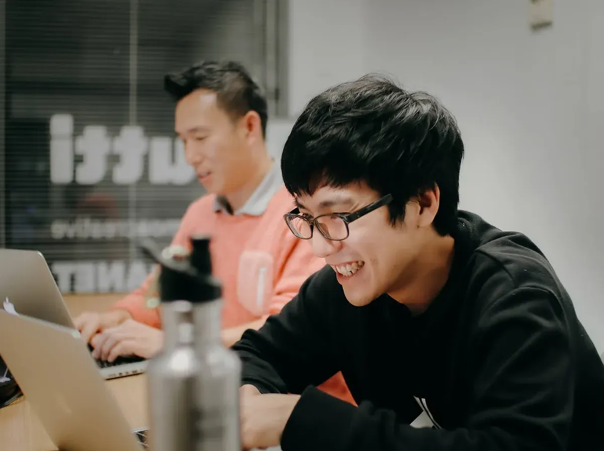 Two Putti developers working through a mobile app build together