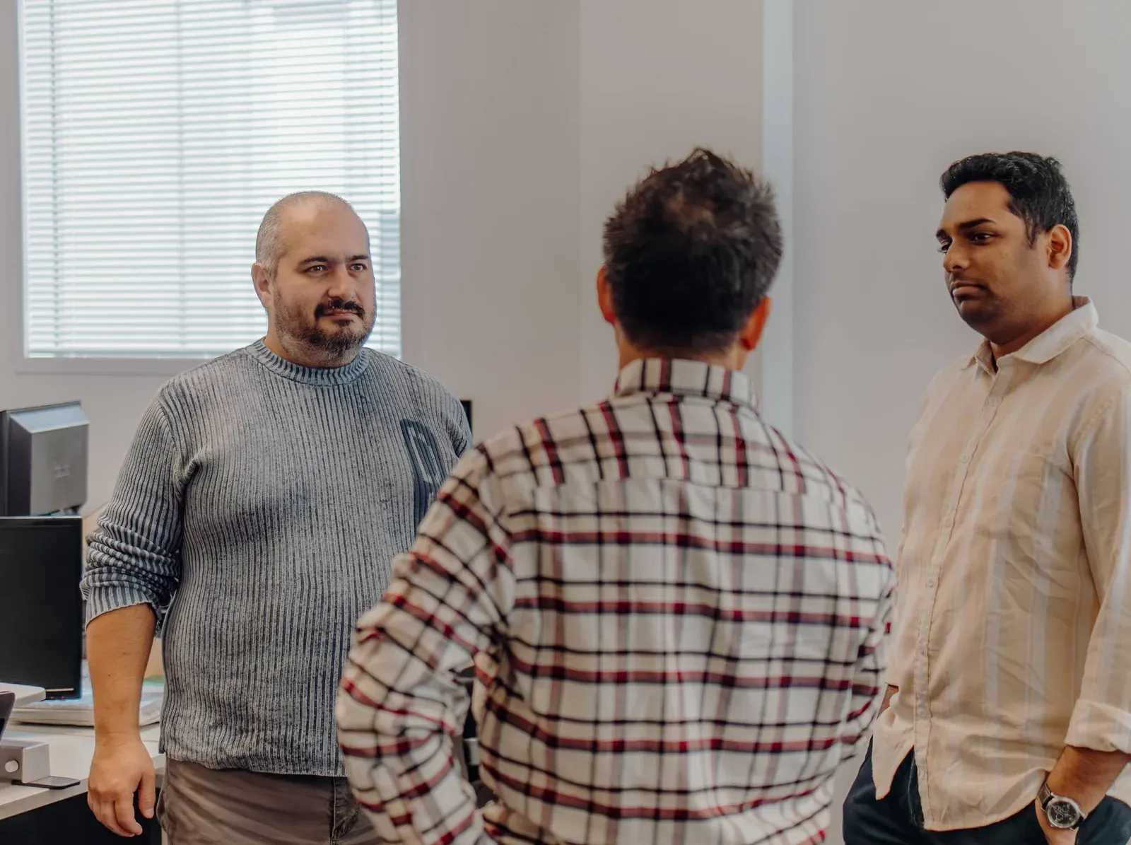 Putti team members talking a project through in the Auckland office