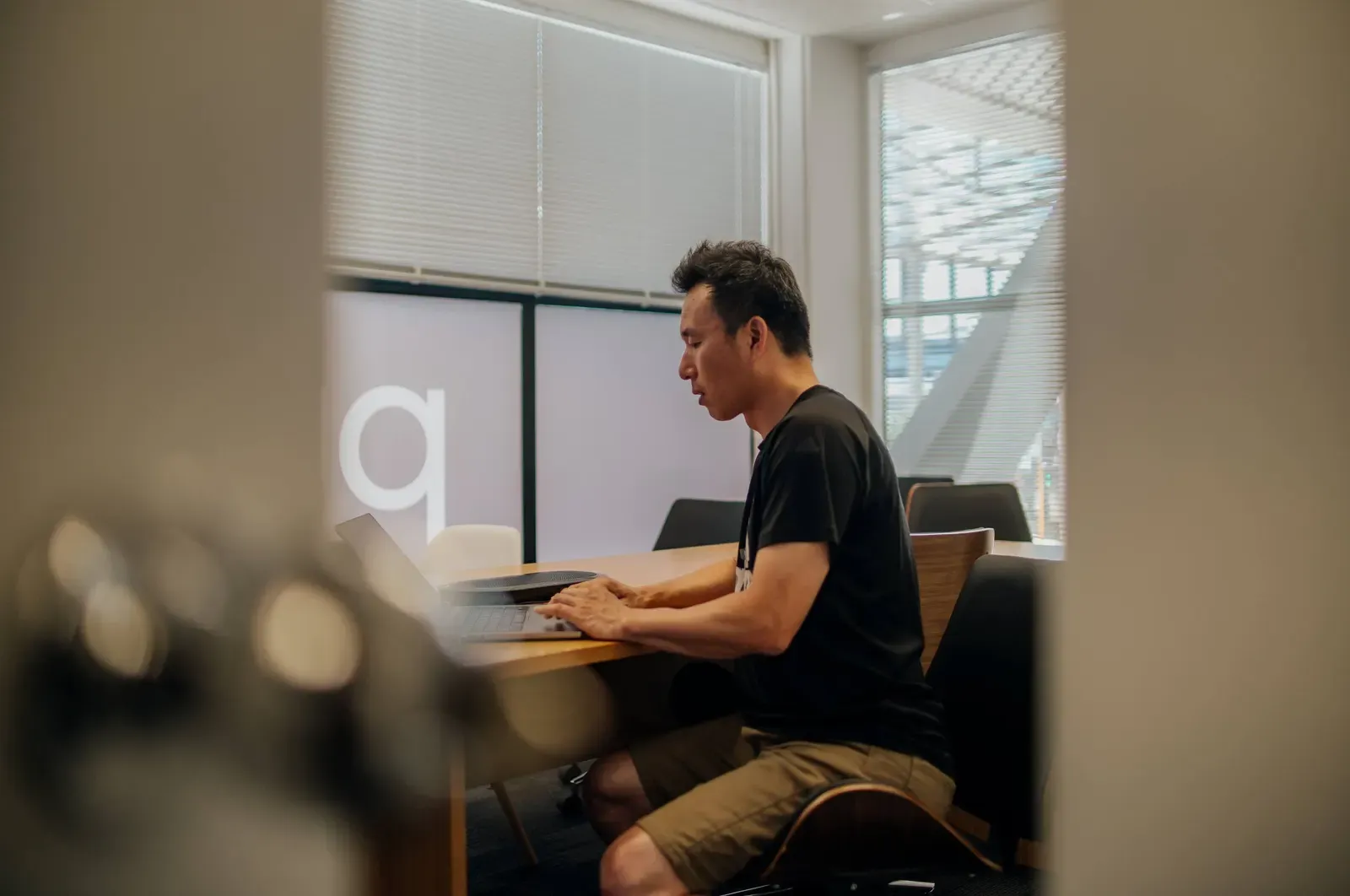 A Putti developer at work on a laptop in the Takapuna meeting room