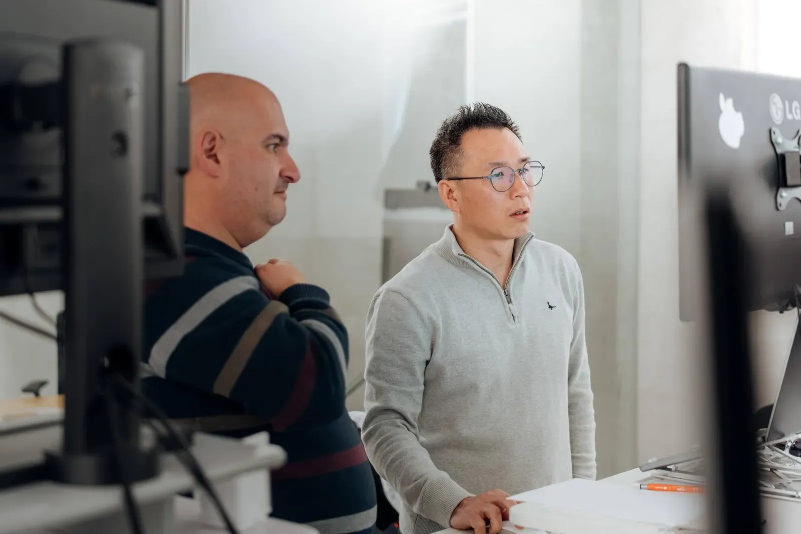 Two Putti engineers reviewing a client system together at a monitor