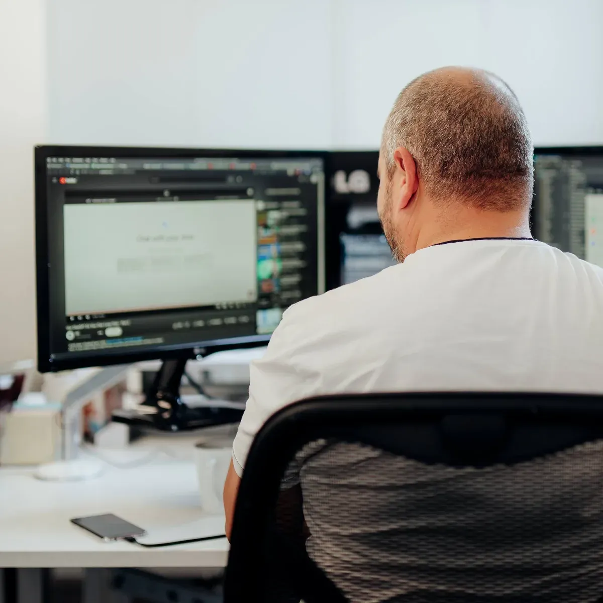 A Putti developer building a custom web platform across two monitors