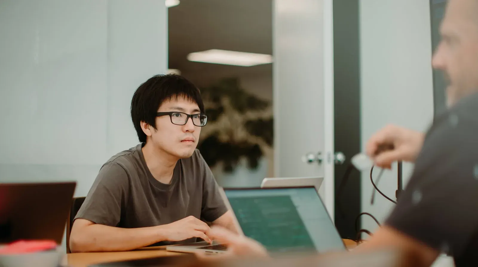 A Putti developer working through code at their desk